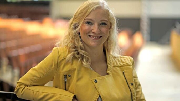 Fenja Makosch mit einer gelben Lederjacke lächelt in die Kamera